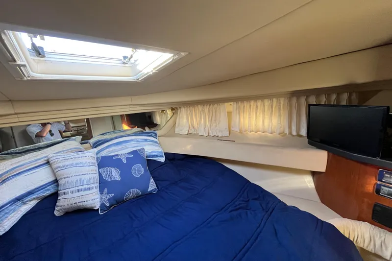 Jus A Lil' Yacht Photos Pics Cozy cabin interior of 2003 Searay 380 yacht with skylight and nautical-themed bedding.