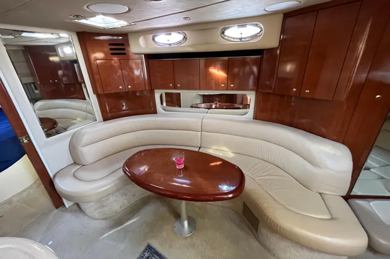Jus A Lil' Yacht Photos Pics Luxurious interior of a 2003 Searay 380 yacht with leather seating and wooden cabinetry.