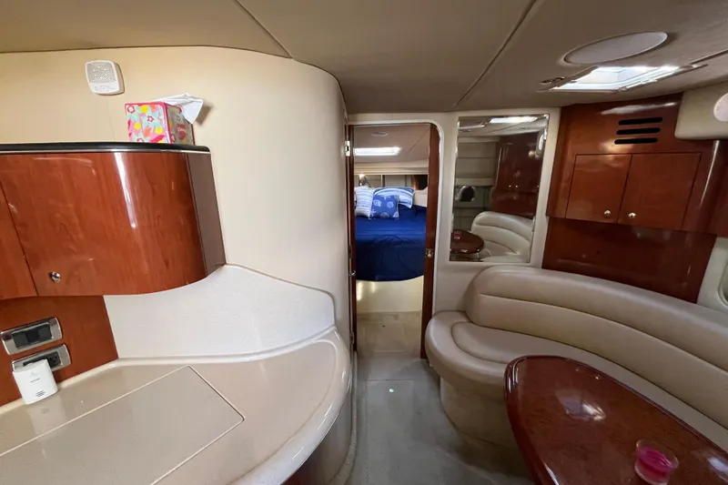 Jus A Lil' Yacht Photos Pics Interior of 2003 Searay 380 yacht with elegant wood finishes and cozy seating area.