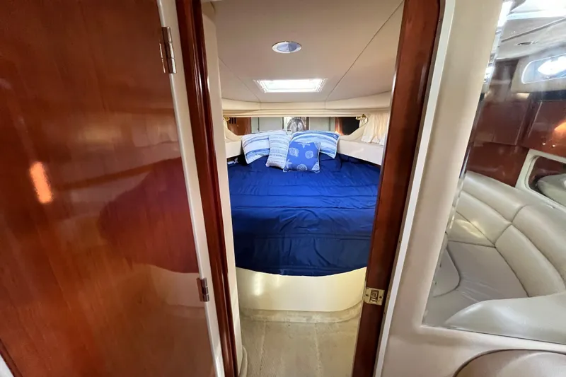 Jus A Lil' Yacht Photos Pics 2003 Searay 380 yacht cabin with blue bedding and wooden interior.