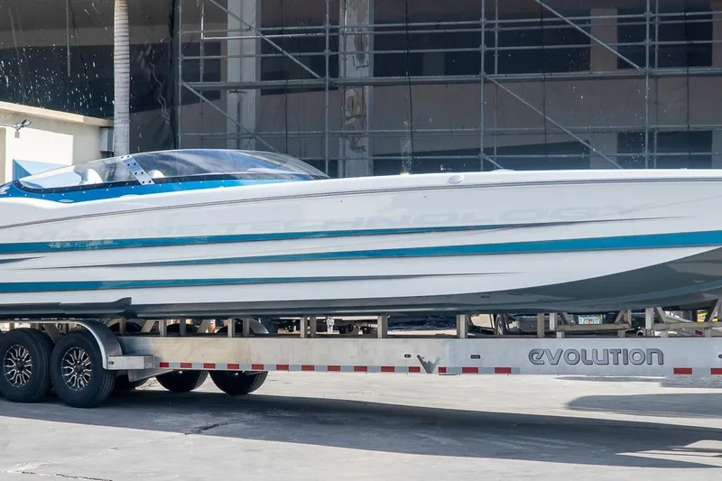  Yacht Photos Pics 2024 MTI 440X powerboat on trailer, sleek design, blue and white color scheme.