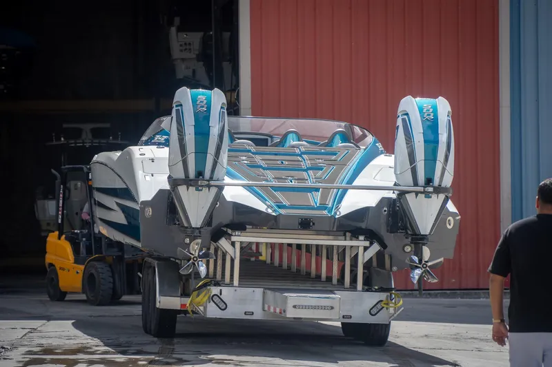  Yacht Photos Pics 2024 MTI 440X boat with dual engines on trailer, ready for transport.