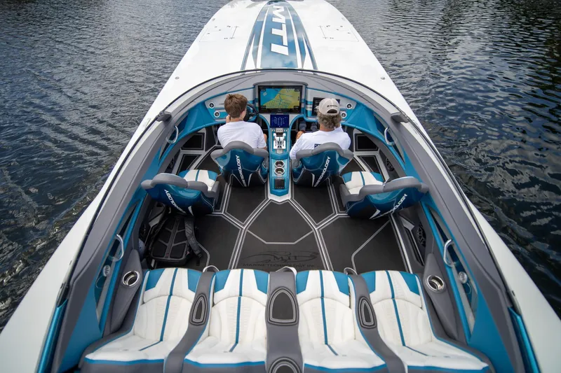  Yacht Photos Pics 2024 MTI 440X speedboat interior with advanced navigation system and stylish seating on water.