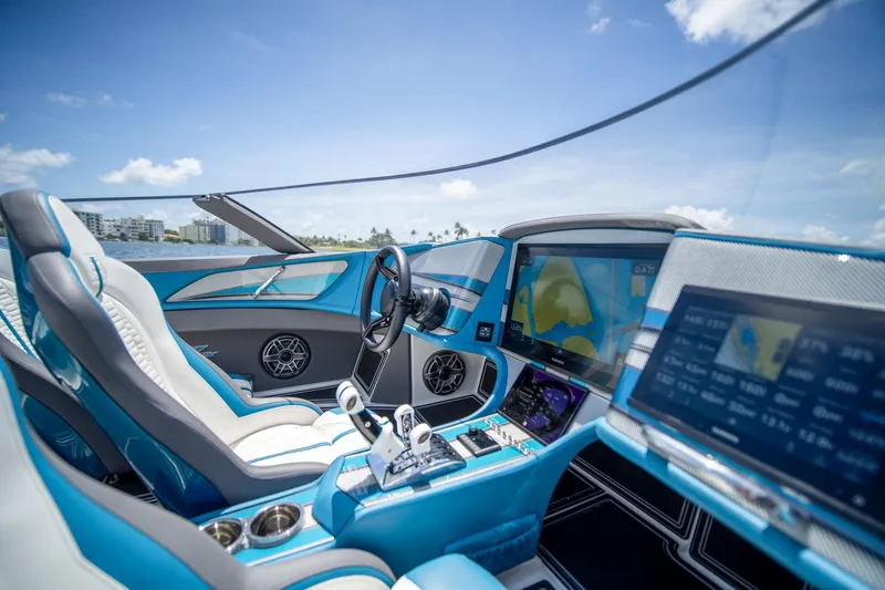  Yacht Photos Pics Luxurious 2024 MTI 440X boat interior with advanced navigation displays and sleek blue design.