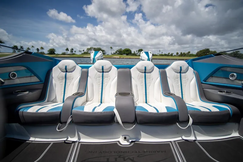  Yacht Photos Pics Luxury seating in 2024 MTI 440X boat, featuring sleek white and blue design.