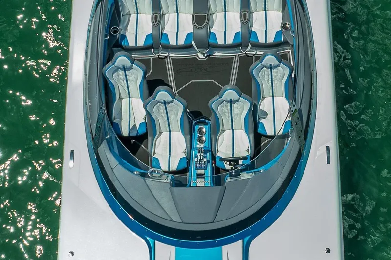  Yacht Photos Pics 2024 MTI 440X boat interior with blue and white seating, viewed from above.