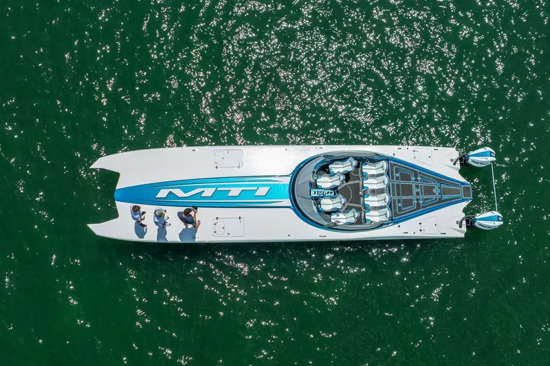  Yacht Photos Pics Aerial view of 2024 MTI 440X powerboat on sparkling green water.