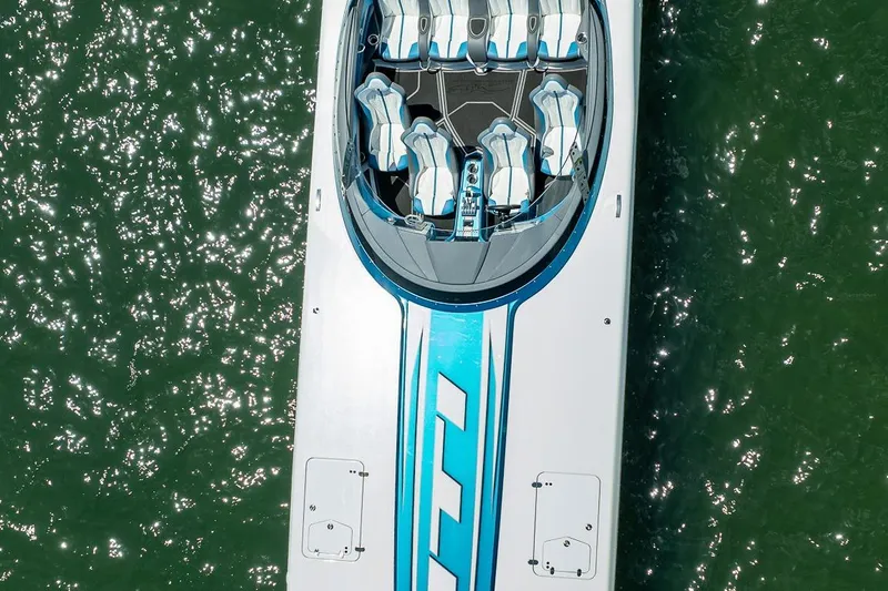  Yacht Photos Pics Aerial view of 2024 MTI 440X speedboat on shimmering water.