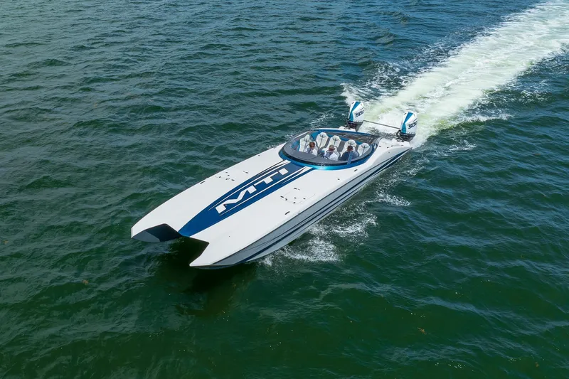  Yacht Photos Pics 2024 MTI 440X powerboat cruising on open water, showcasing sleek design and performance.