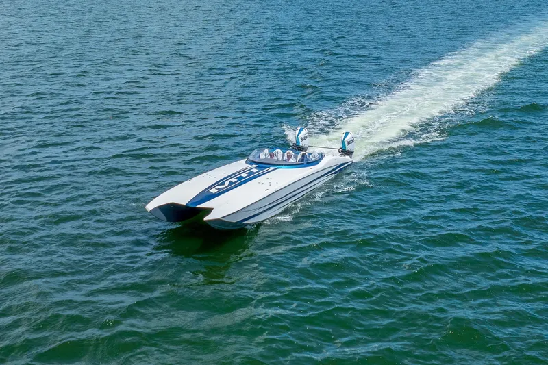  Yacht Photos Pics 2024 MTI 440X speedboat cruising on open water, showcasing sleek design and powerful performance.