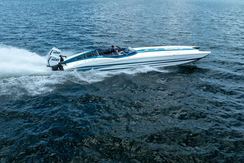  Yacht Photos Pics 2024 MTI 440X speedboat cruising on open water, showcasing powerful dual engines.