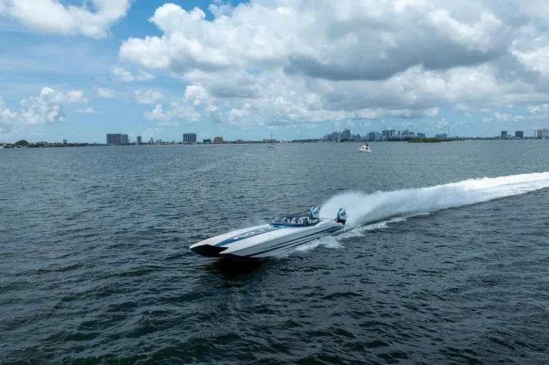 Yacht Photos Pics 2024 MTI 440X speedboat cruising on open water under a cloudy sky.