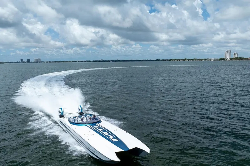  Yacht Photos Pics 2024 MTI 440X speedboat cruising on open water under a cloudy sky.