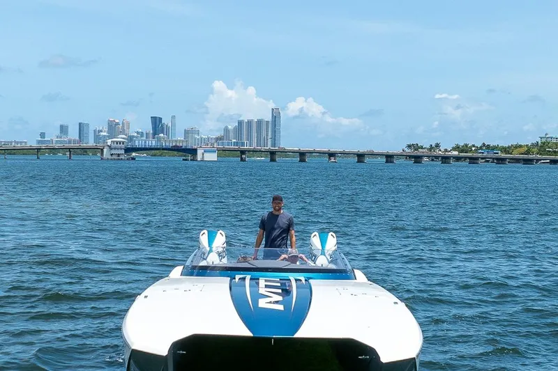  Yacht Photos Pics 2024 MTI 440X boat on water with city skyline in background.