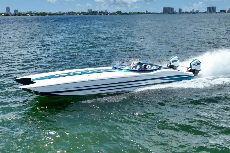  Yacht Photos Pics 2024 MTI 440X speedboat cruising on open water, showcasing sleek design and powerful engines.