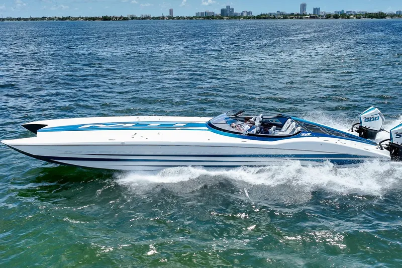  Yacht Photos Pics 2024 MTI 440X speedboat cruising on open water, showcasing sleek design and powerful engines.