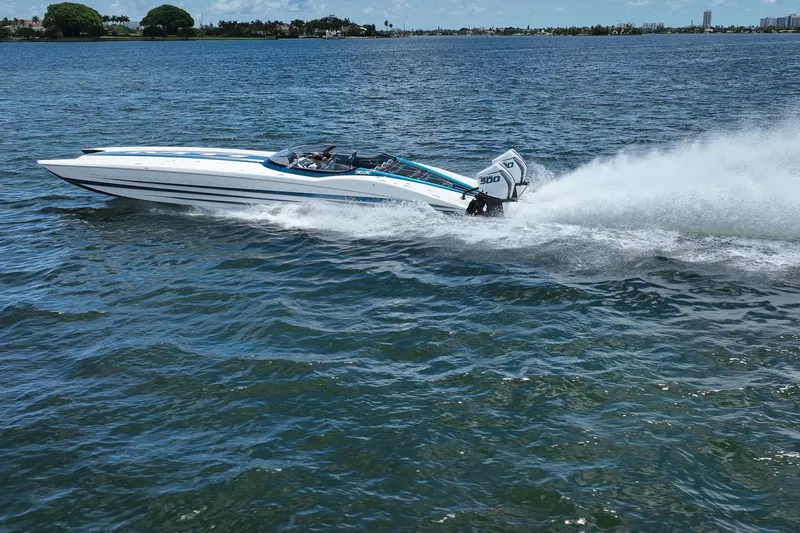  Yacht Photos Pics 2024 MTI 440X speedboat cruising on open water, showcasing powerful performance.