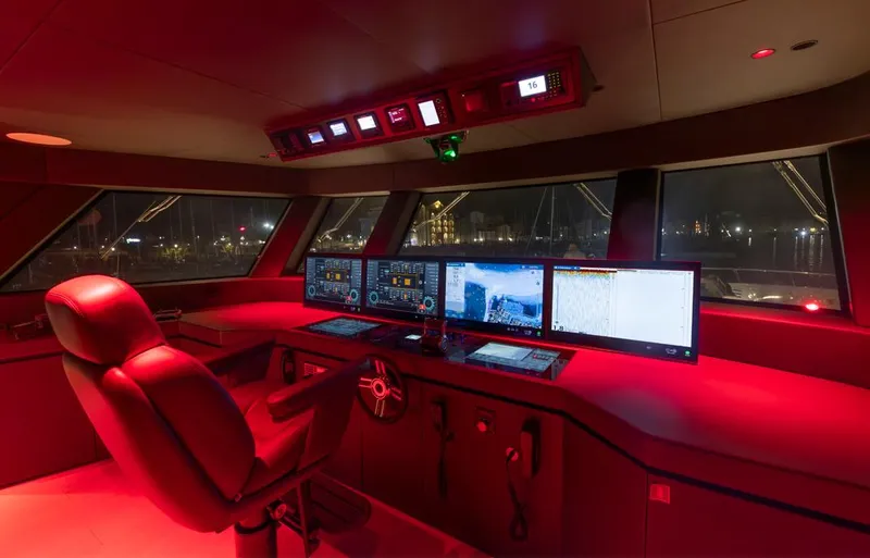 Doge 400 Yacht Photos Pics Red-lit control room of Ocean King Doge 400 yacht, 2027 model, with advanced navigation systems.