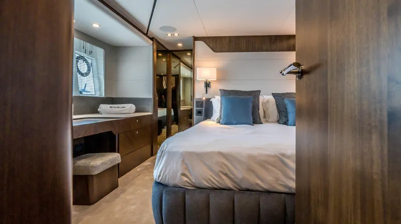  Yacht Photos Pics Luxurious bedroom interior of 2026 Fairline Phantom 65 yacht with elegant furnishings.