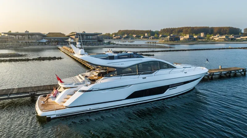  Yacht Photos Pics 2026 Fairline Phantom 65 yacht docked in a serene marina setting.