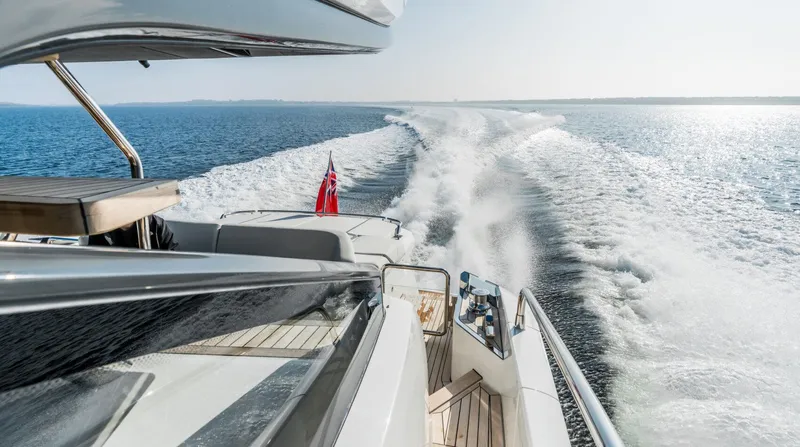 Yacht Photos Pics 2026 Fairline Phantom 65 yacht cruising on open water, leaving a wake behind.