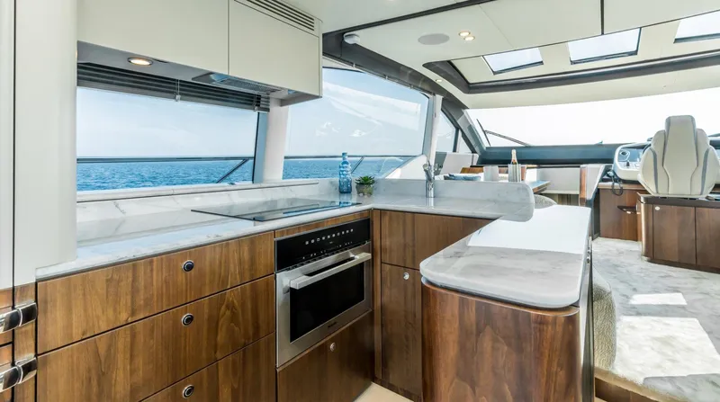  Yacht Photos Pics Luxurious interior of 2026 Fairline Phantom 65 yacht with modern kitchen and ocean view.