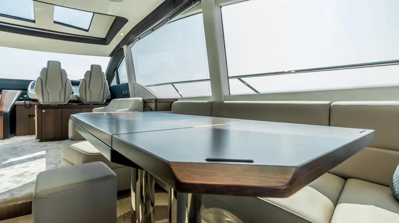  Yacht Photos Pics Interior of 2026 Fairline Phantom 65 yacht with sleek dining area and panoramic windows.