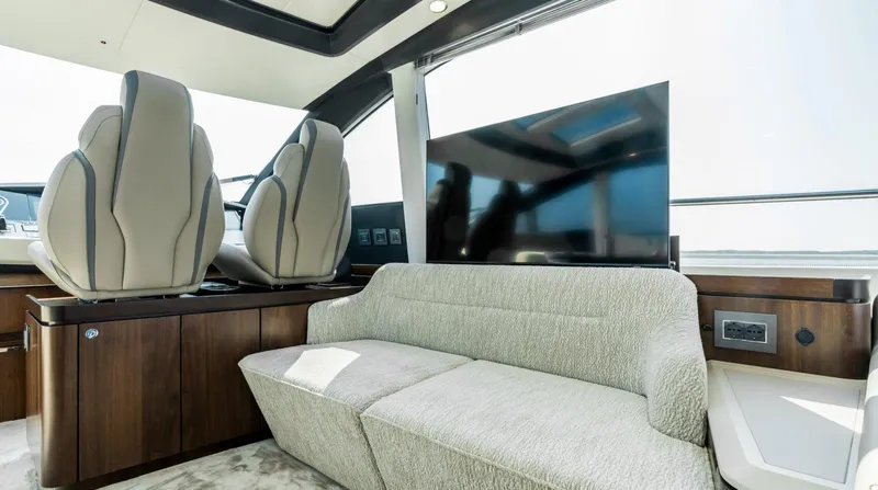  Yacht Photos Pics Luxurious interior of 2026 Fairline Phantom 65 yacht with modern seating and large TV.
