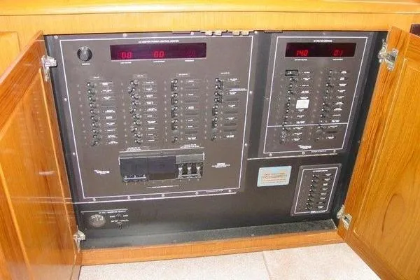  Yacht Photos Pics Electrical panel inside 1996 Viking 50 Convertible yacht, featuring circuit breakers and digital displays.