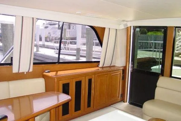  Yacht Photos Pics Interior of a 1996 Viking 50 Convertible yacht with wood accents and large windows.