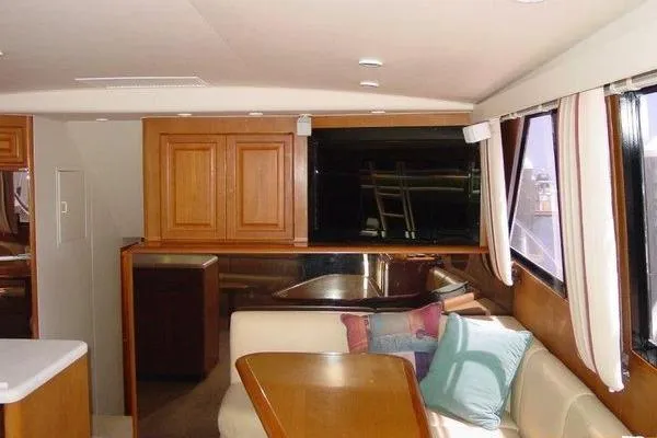  Yacht Photos Pics Interior of a 1996 Viking 50 Convertible yacht with wooden cabinetry and seating area.