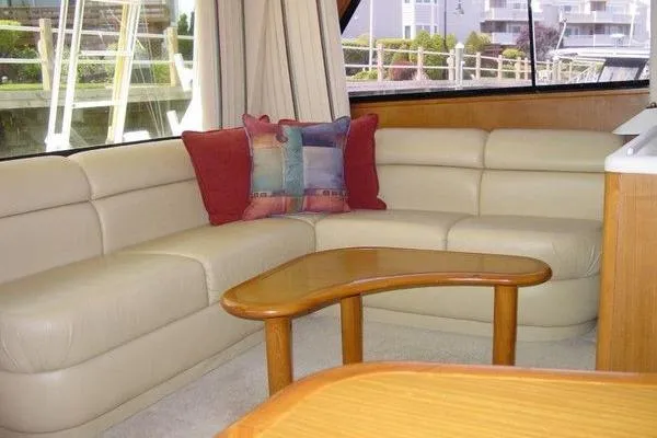  Yacht Photos Pics Luxurious interior of 1996 Viking 50 Convertible yacht with cream leather seating and decorative pillows.