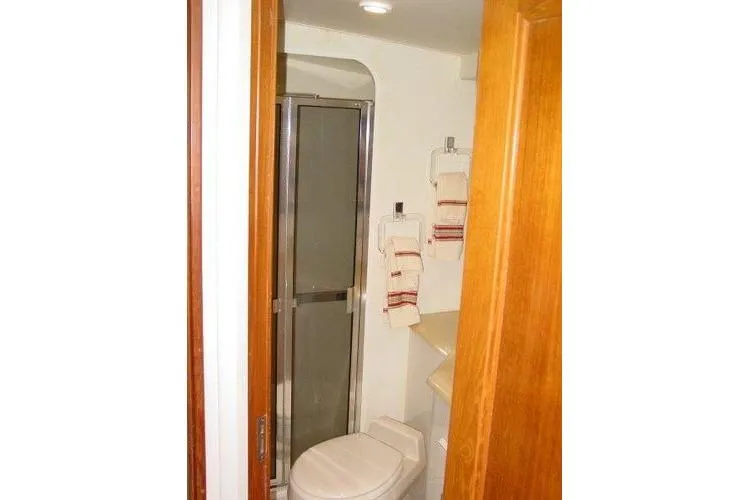  Yacht Photos Pics Bathroom interior of 1996 Viking 50 Convertible yacht with shower and toilet.