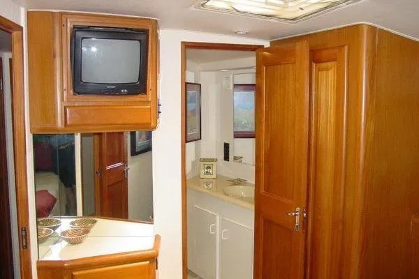  Yacht Photos Pics 1996 Viking 50 Convertible yacht interior with wood cabinetry and compact TV.