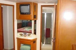  Yacht Photos Pics 1996 Viking 50 Convertible yacht interior with TV, mirror, and bathroom door.