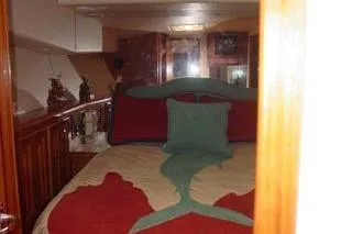  Yacht Photos Pics Interior cabin of a 1996 Viking 50 Convertible yacht with a cozy bed setup.