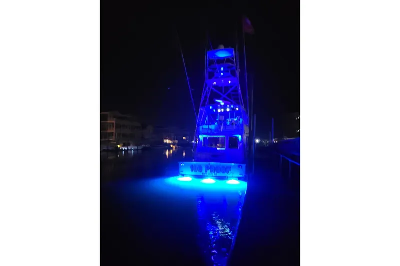  Yacht Photos Pics 1996 Viking 50 Convertible yacht illuminated with blue lights at night.