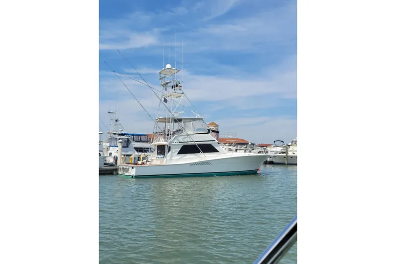  Yacht Photos Pics 1996 Viking 50 Convertible yacht docked in a marina under a clear blue sky.
