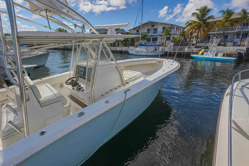  Yacht Photos Pics 2017 Sea Hunter 39 boat docked in a marina with palm trees and buildings.