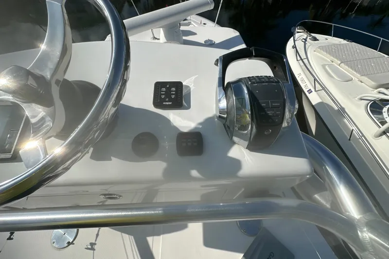  Yacht Photos Pics Control panel of a 2017 Sea Hunter 39 boat with steering wheel and throttle.