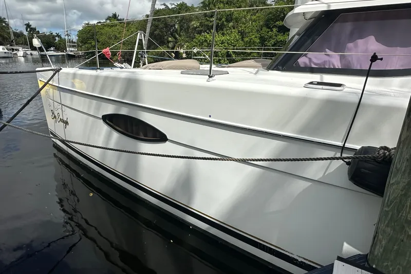 Big Enough Yacht Photos Pics 2014 Fountaine Pajot Helia 44 catamaran docked, side view with lush greenery background.