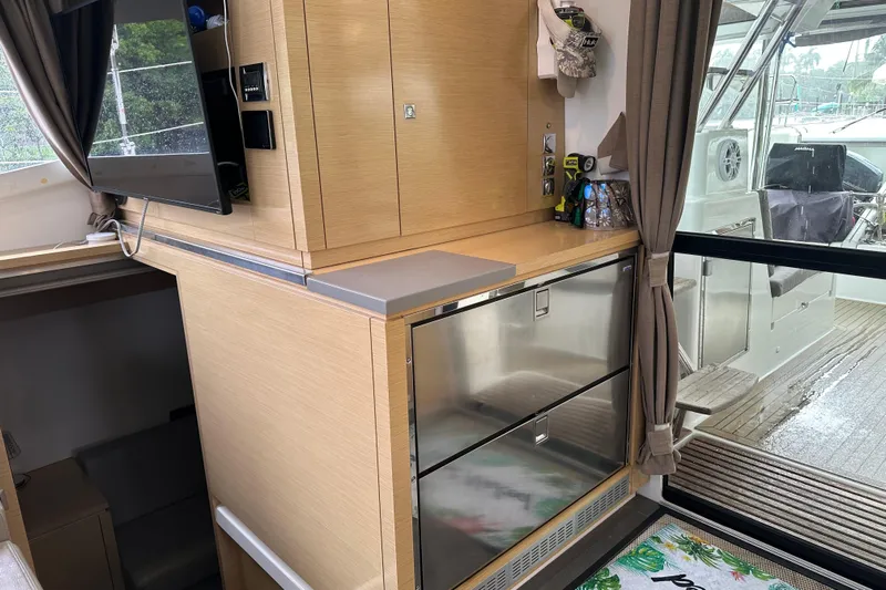 Big Enough Yacht Photos Pics Interior of 2014 Fountaine Pajot Helia 44 catamaran with modern cabinetry and sliding glass door.