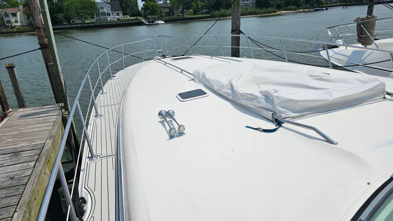  Yacht Photos Pics 1999 Sea Ray 500 Sundancer yacht docked by the water, showcasing its sleek deck design.