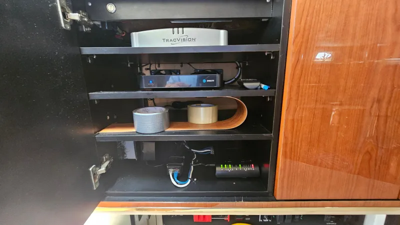  Yacht Photos Pics 1999 Sea Ray 500 Sundancer cabinet with electronic equipment and accessories neatly organized.