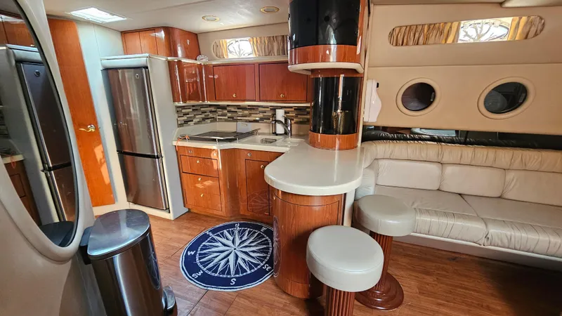 Yacht Photos Pics Luxurious interior of 1999 Sea Ray 500 Sundancer yacht with modern kitchen and seating area.