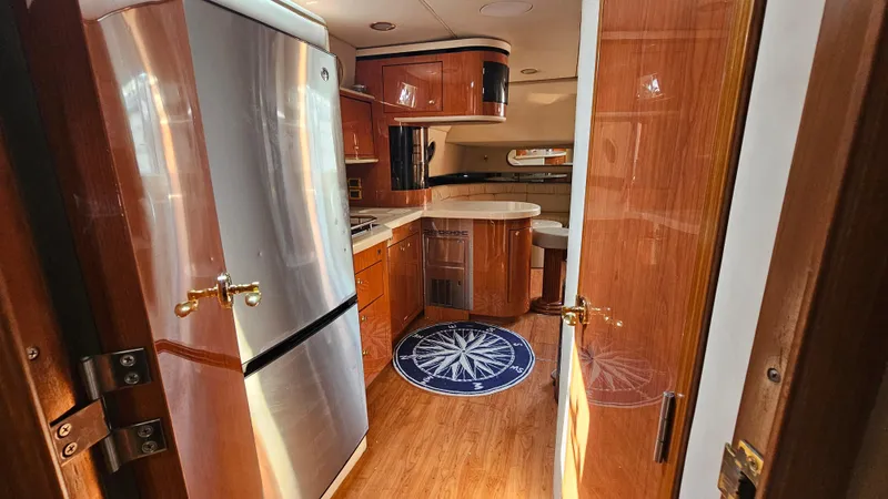  Yacht Photos Pics Interior of 1999 Sea Ray 500 Sundancer yacht with modern kitchen and wood finishes.