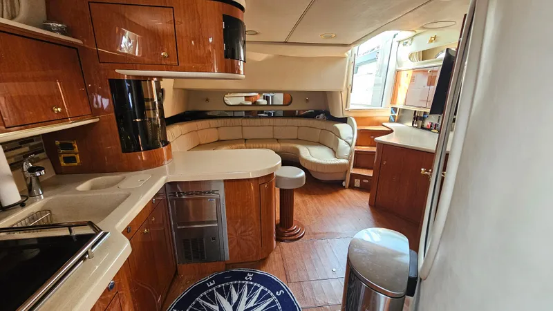  Yacht Photos Pics Luxurious interior of a 1999 Sea Ray 500 Sundancer yacht with elegant wood finishes.