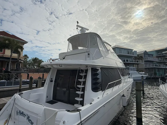  Yacht Photos Pics 2002 Carver 530 Voyager Pilothouse yacht docked at marina under cloudy sky.