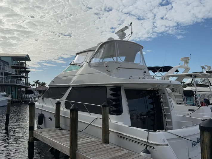  Yacht Photos Pics 2002 Carver 530 Voyager Pilothouse yacht docked under a cloudy sky.