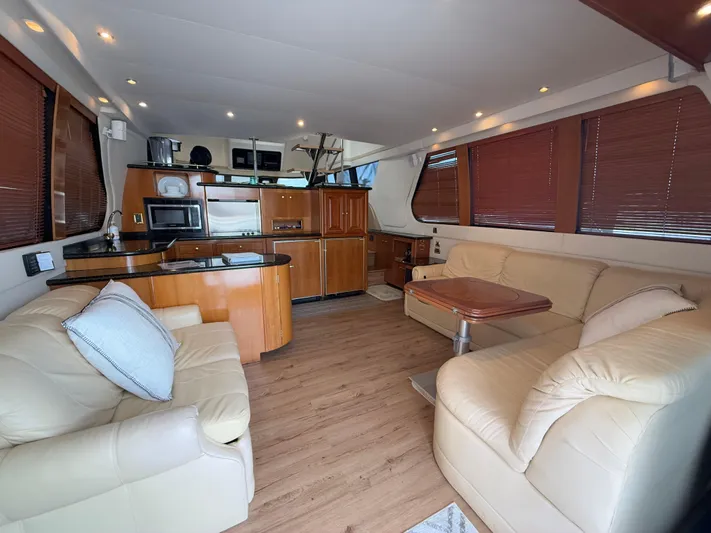  Yacht Photos Pics Luxurious interior of 2002 Carver 530 Voyager Pilothouse with leather seating and modern kitchen.